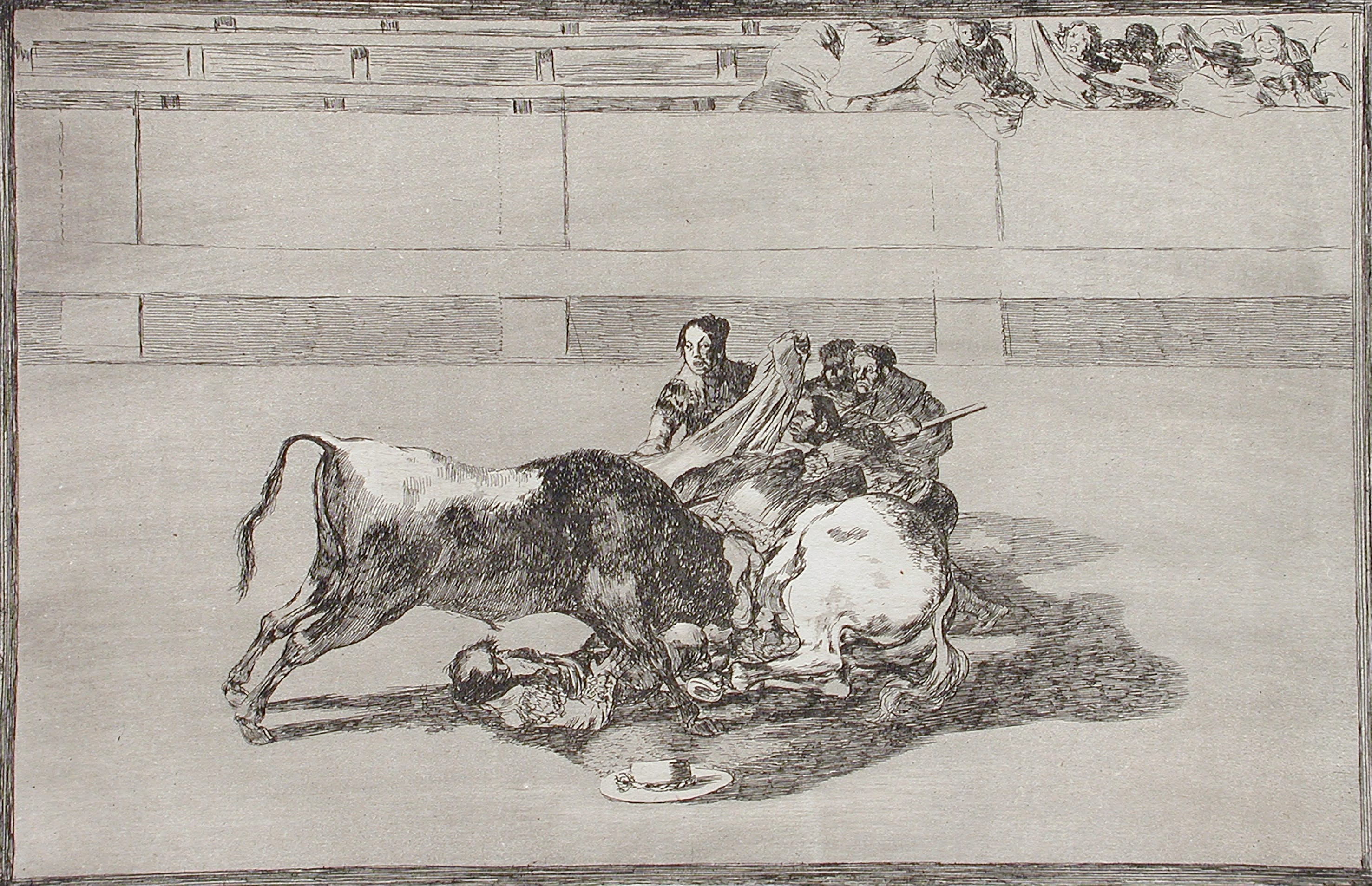 A picador is unhorsed and falls under the bull